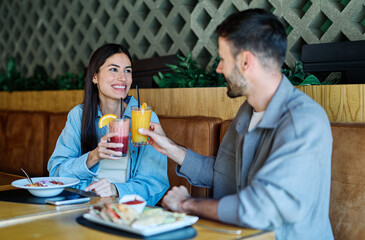 Portrait of ayoung romantic couple in restaurant having lunch