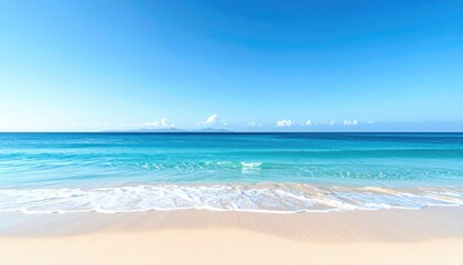 Obraz premium Serene Ocean Waves Gently Rolling onto a Sandy Beach Under a Clear Blue Sky