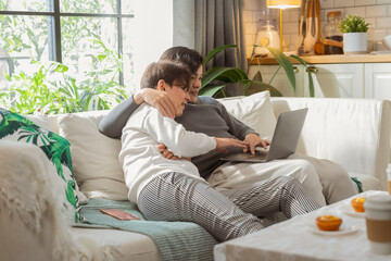 Asian LGBTQ male couple reviews monthly financial bills and household expenses together at home, managing shared budget planning, savings goals and responsible money management for their future 