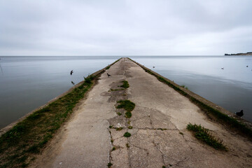 Old concrete pier under a cloudy sky in Nida, Curonian Spit and Curonian Lagoon, Lithuania