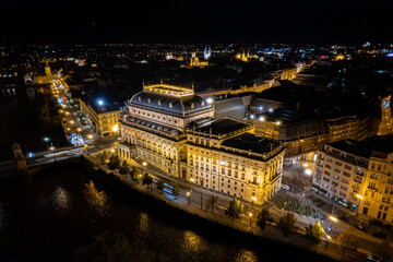 Beautiful Aerial view of Pragues National Theatre (Národní divadlo) at night with view of the city and the Vltava