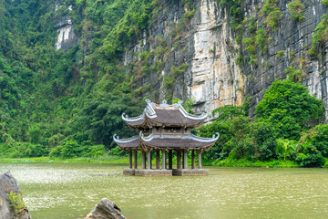 Floating temple in a lake at the Trang An Scenic Landscape Complex, Ninh Binh, Vietnam. Tam Coc National Park Sightseeing tour to grottoes.