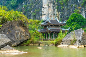 Floating temple in a lake at the Trang An Scenic Landscape Complex, Ninh Binh, Vietnam. Tam Coc National Park Sightseeing tour to grottoes.