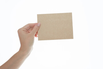 Woman's Hand Holding Blank Brown Kraft Paper Card on White Background