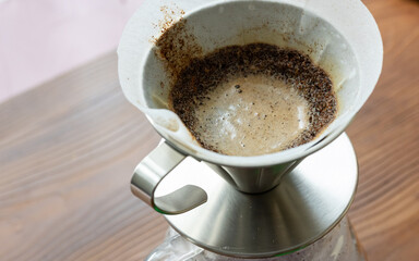 barista quick metal filter coffee brewing close up	