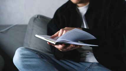 A man flips through the pages of a book and engrossed in a gripping detective novel in the library.
Reading a book and self-improvement.
A smart guy with a book in his hands.