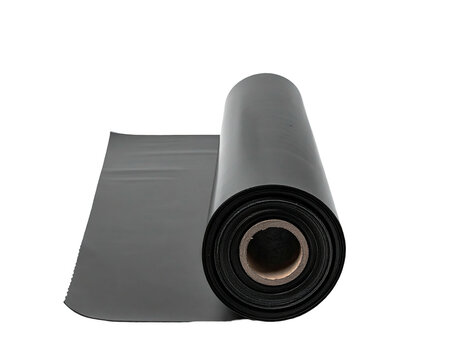 A partially rolled sheet of opaque, dark material sits against a stark, black background