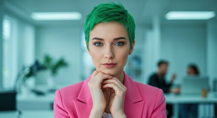 Woman with short green hair in pink blazer looks confidently at camera in bright modern office. Perfect for diversity, inclusive culture, and professional content.