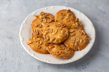 Tasty peanut cookies on light background