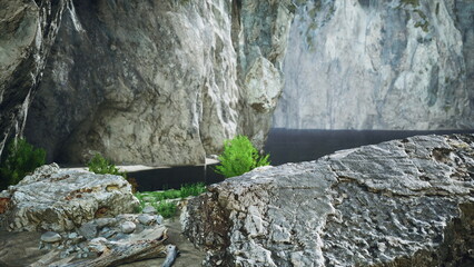 A serene landscape reveals striking cliffs towering over a calm body of water. Green shrubs line the shore, while rocks create a peaceful setting. The atmosphere is tranquil and inviting.