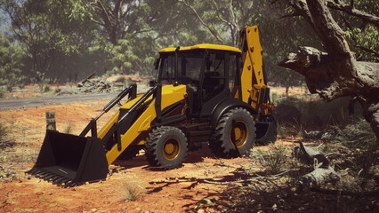 A powerful yellow backhoe is parked on a dirt road surrounded by trees. Sunlight filters through the foliage while construction materials are scattered nearby, showcasing a busy worksite.