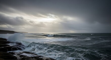 Fototapeta premium Dramatic ocean waves crashing on rocky shoreline under a cloudy sky