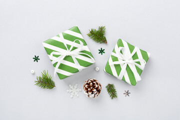 Striped Christmas gift boxes on color background, top view