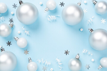Grey Christmas balls with decor on color background, top view