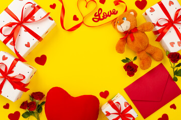 Valentine's Day composition with gifts and red roses on color background, top view