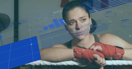Female boxer in tank top leaning on ropes in boxing ring, studying digital overlay, red wraps