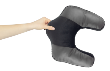 Neck pillow in hand, outstretched arm with neck pillow, isolated from background