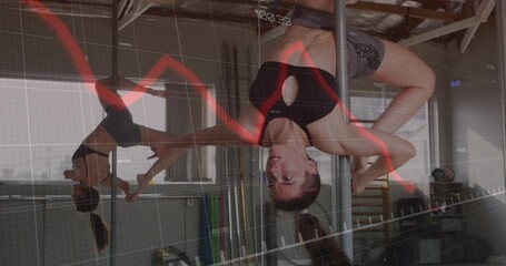 Performing inverted pole move woman wearing sportswear in dance studio, with red graph grid overlay