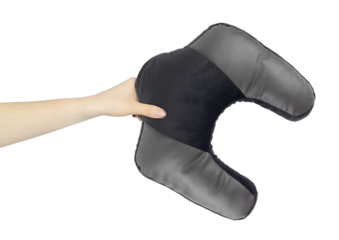 Neck pillow in hand, outstretched arm with neck pillow, isolated from background