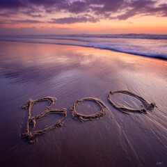 “Boo” Written Naturally in Wet Sand with Thin Hand-Drawn Grooves and Soft Ocean Wave – ideal for holiday celebrations