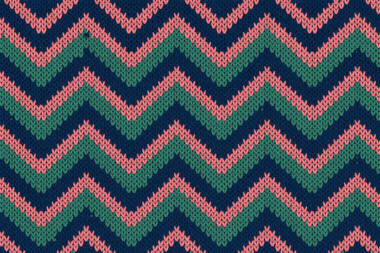 Colorful zigzag knit pattern in shades of green, pink, and navy blue with a cozy winter vibe