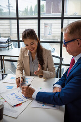 Fototapeta premium Colleagues collaborating on business data analysis in office meeting