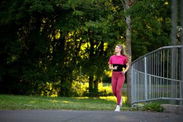 Woman Jogging in Park Wearing Pink Athletic Wear