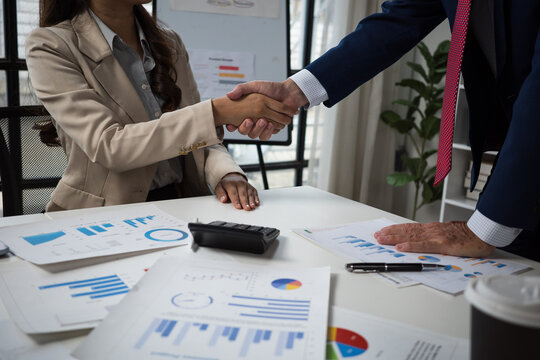 Business partners shaking hands finalizing agreement in office