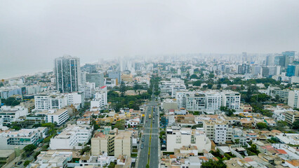 Drone photography of a busy avenue in the heart of San Isidro on a foggy winter day.