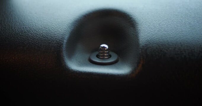Extreme close-up of a car door lock pin, focus on automotive security, detail, and modern vehicle interior.