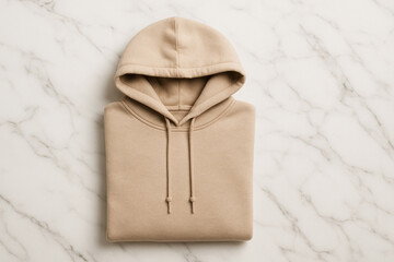 Minimalist folded beige hoodie on marble background fashion flat lay apparel design cozy streetwear clothing photography with soft texture and casual style