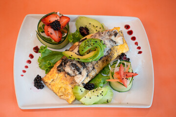 Comida vegetariana con omelette, pepino y moras