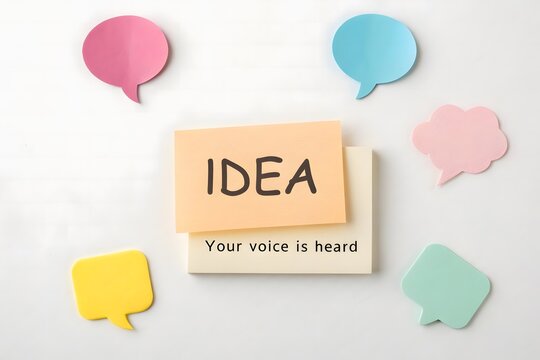 Flat lay of speech bubbles and an idea message in pastel