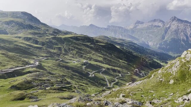 Pan of Splugen Pass hairpin turns with Teurihorn and lens flare - Italian Alps