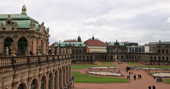 Dresden Germany historic Zwinger palace courtyard pan 4K. Industrial center of East Germany, now unified German, European Union (EU) and NATO. Total destruction in WW II. Palace rebuilt historically.