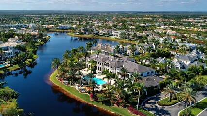 Aerial view of luxury homes and a lake in a residential community, 4k video