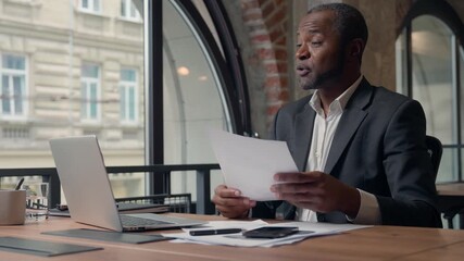 African American businessman talking business video call presenting diagram stats in office male CEO boss man leader employer showing documet stats financial result communicate conference negotiation - Powered by Adobe