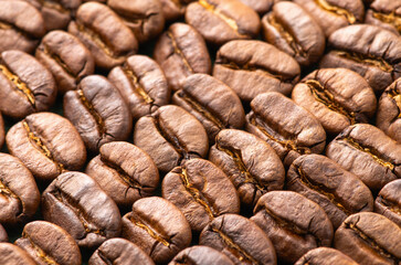 Background of roasted coffee beans. Top view, close-up.