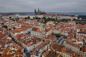 Beautiful aerial view St. Nicholas Church in the Lesser Town of Prague, Czech Republic — stunning baroque masterpiece surrounded by colorful old buildings and cobblestone streets
