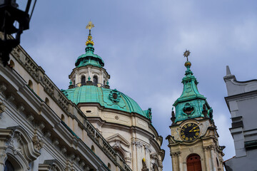 Beautiful aerial view St. Nicholas Church in the Lesser Town of Prague, Czech Republic — stunning baroque masterpiece surrounded by colorful old buildings and cobblestone streets