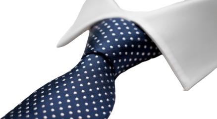Close-up of a navy polka dot tie on a white collared shirt