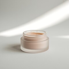 Glass jar of cream with soft light and shadow
