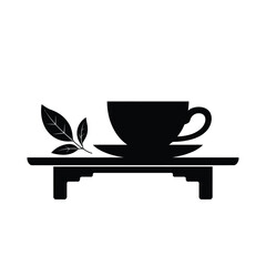 Black silhouette of a tea cup and saucer with a tea leaf sprig