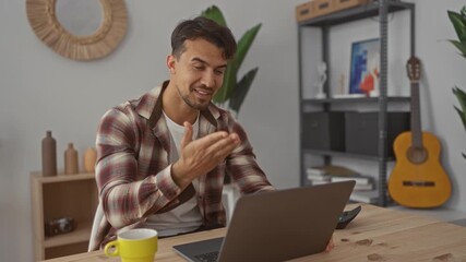 Young man engaging in a video call in a cozy office with plants, guitar, and shelves creating a productive indoor workspace. - Powered by Adobe