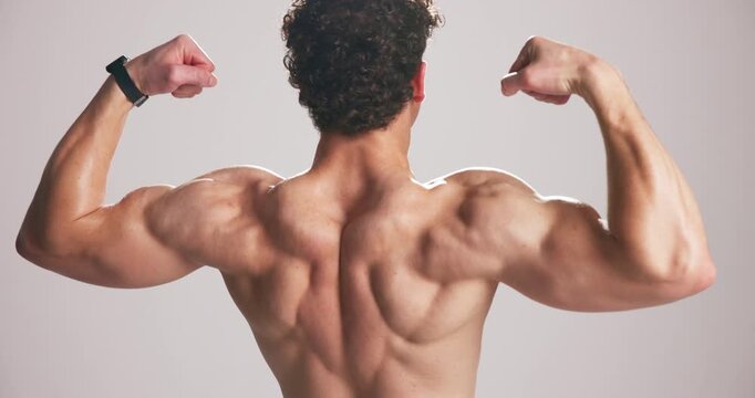 Studio, biceps and man flex muscle for growth, development and strength with power. Strong back, shirtless person and bodybuilder with fitness progress, exercise or physique on white background space