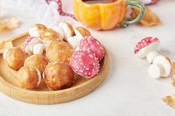 Autumn cozy tea party with creative marshmallow mushrooms for children the background of autumn decorations, handmade goodies.