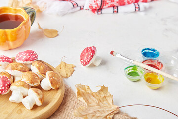 Autumn cozy tea creativity, coloring creative marshmallow fly agaric, mushrooms for kids. Background of autumn decorations, handmade goodies.
