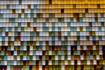 Colorful transparent glass bricks forming a decorative wall