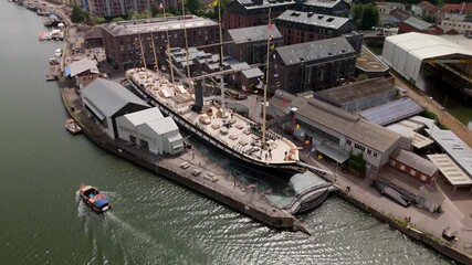 Bristol England: 28th July 2025: Drone view of Brunel's SS Great Britain rests at the dock in Bristol, surrounded by historic buildings along the River Avon