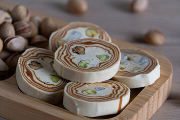 Halva and Pistachio Nuts on Wooden Tray